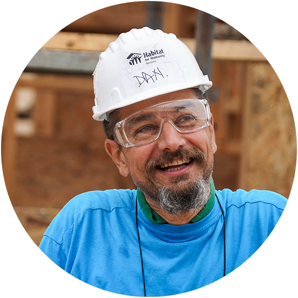 smiling construction worker with habitat for humanity hardhat 